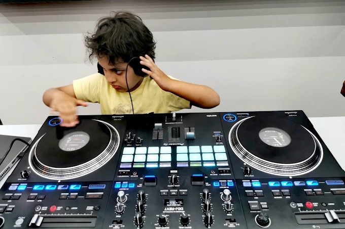 Child learning DJing at DJ World showroom in Bahrain on AlphaTheta Pioneer DJ controller